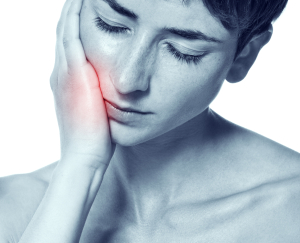 Young woman in pain is having toothache